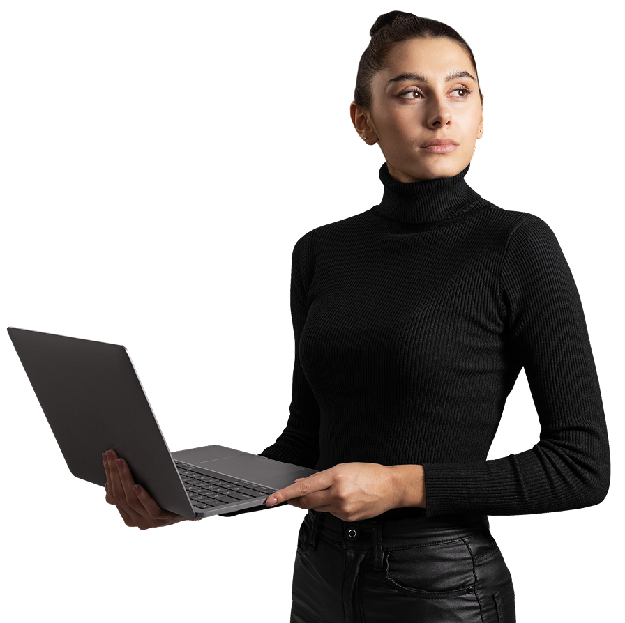 Woman in black turtleneck holding a laptop and looking to the side against a black background.