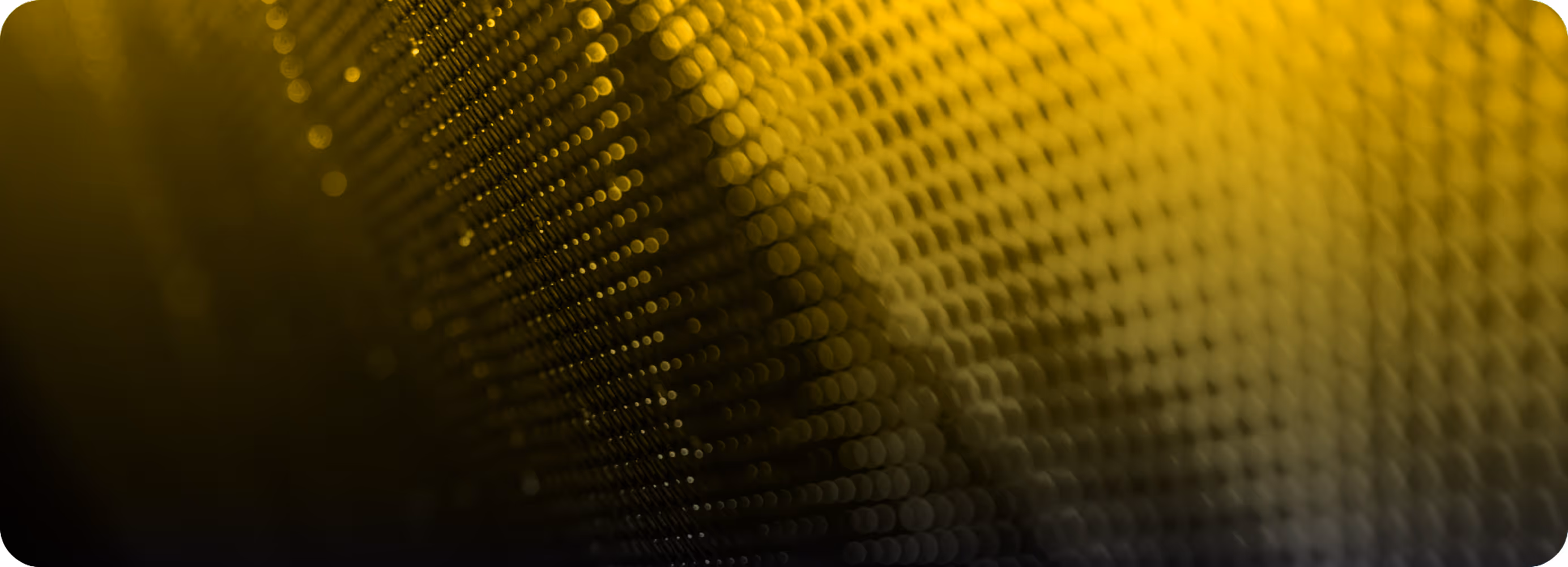 Abstract close-up of yellow and black textured pattern with round shapes and gradient lighting.