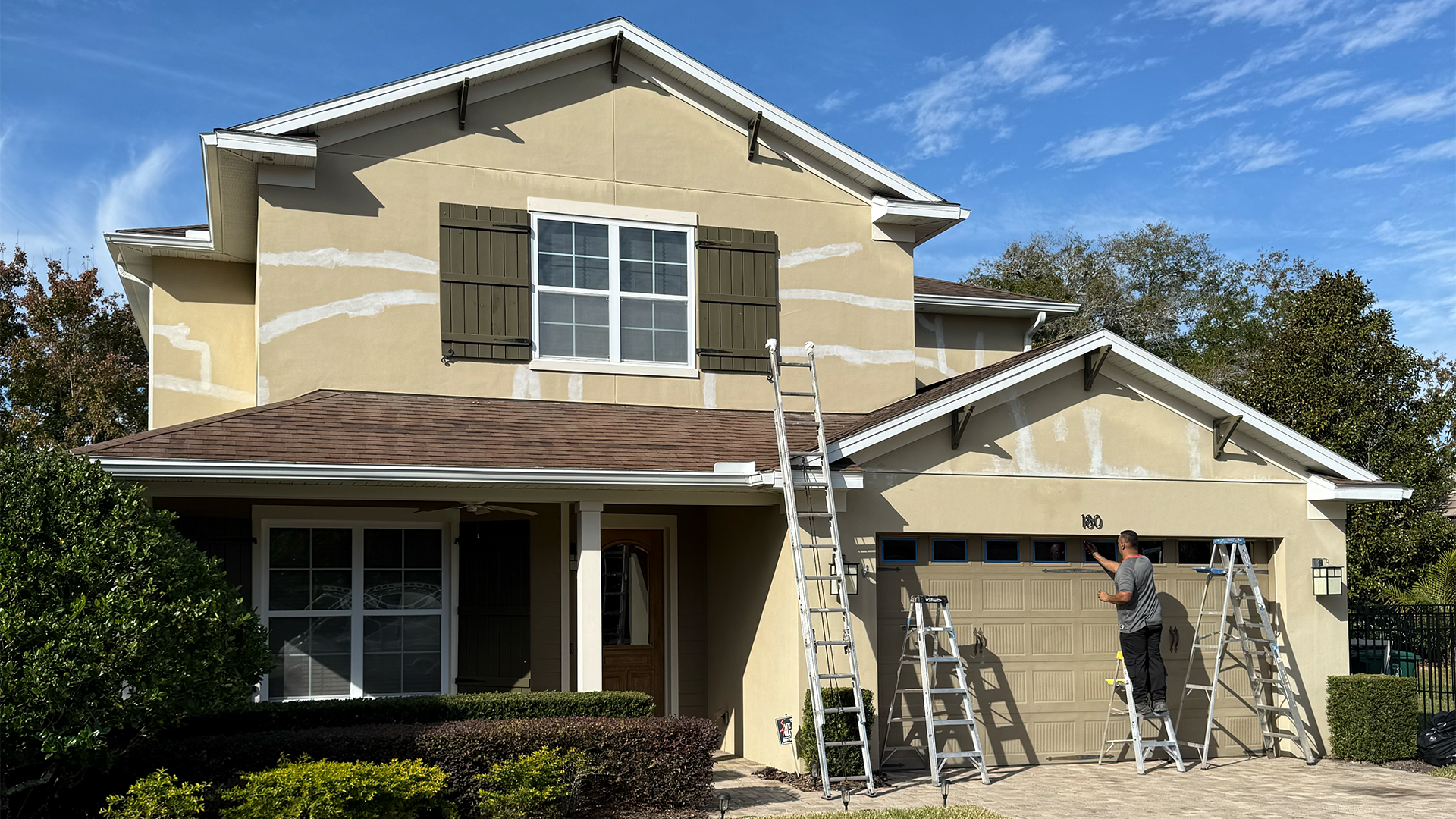 Two story home exterior before repaint during preparation