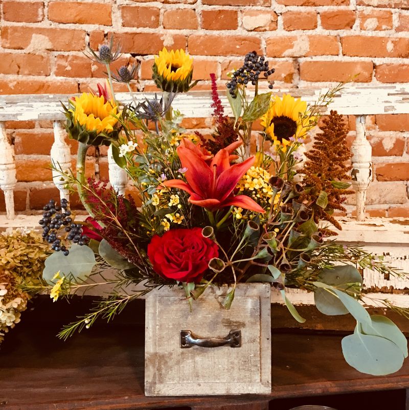 Rustic fall arrangement with sunflowers and red roses