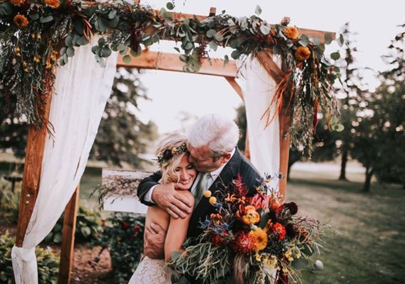 A bride sharing a moment at her wedding, flowers by Simply Blooming