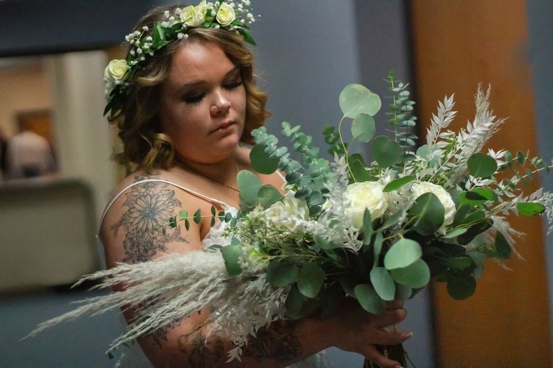 Bride wearing a fresh flower crown holding her bouquet