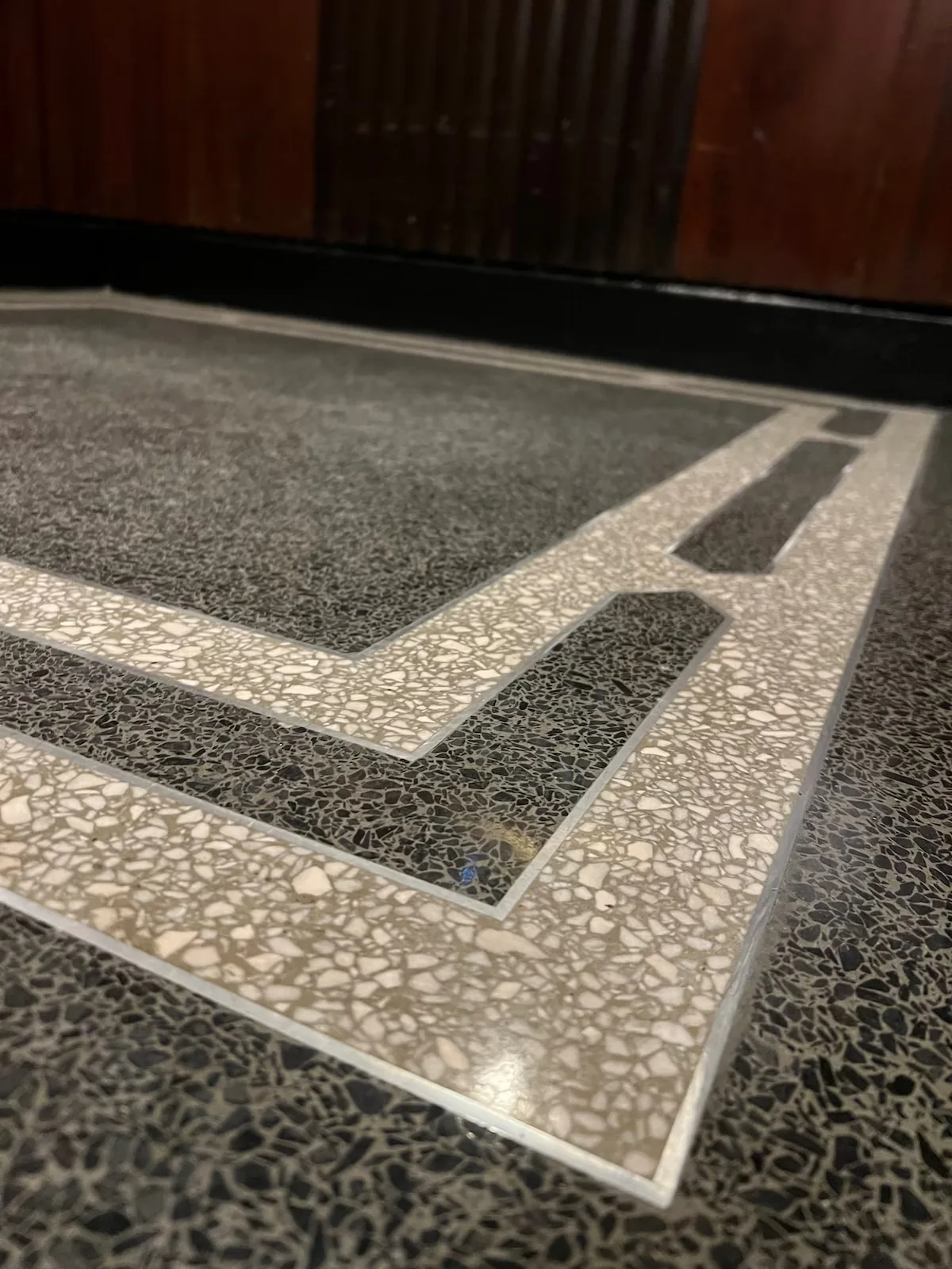 Custom terrazzo divider layout with graphic border pattern and polished aggregate field from 241 Central Park West