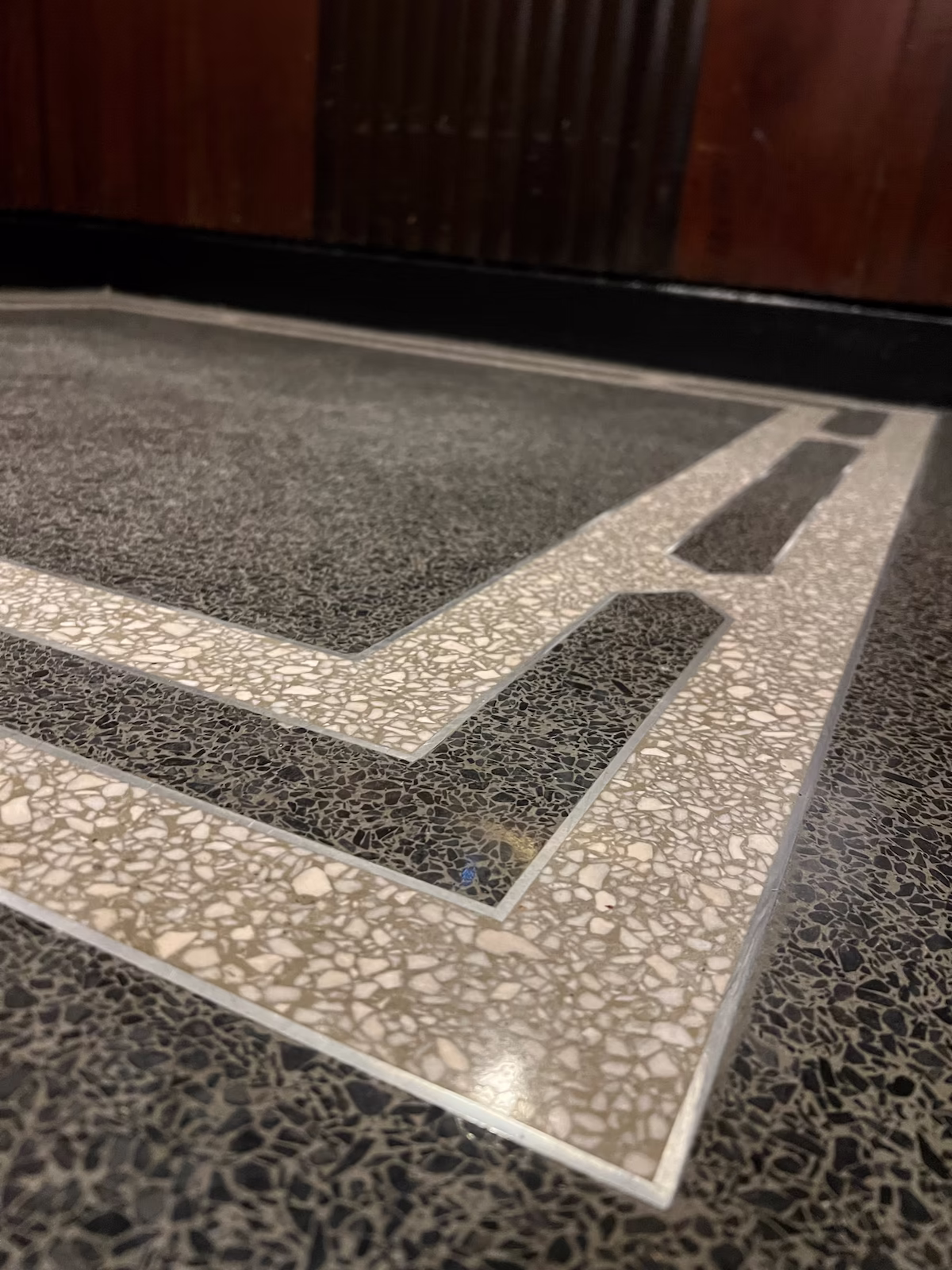 Custom terrazzo divider layout with graphic border pattern and polished aggregate field from 241 Central Park West