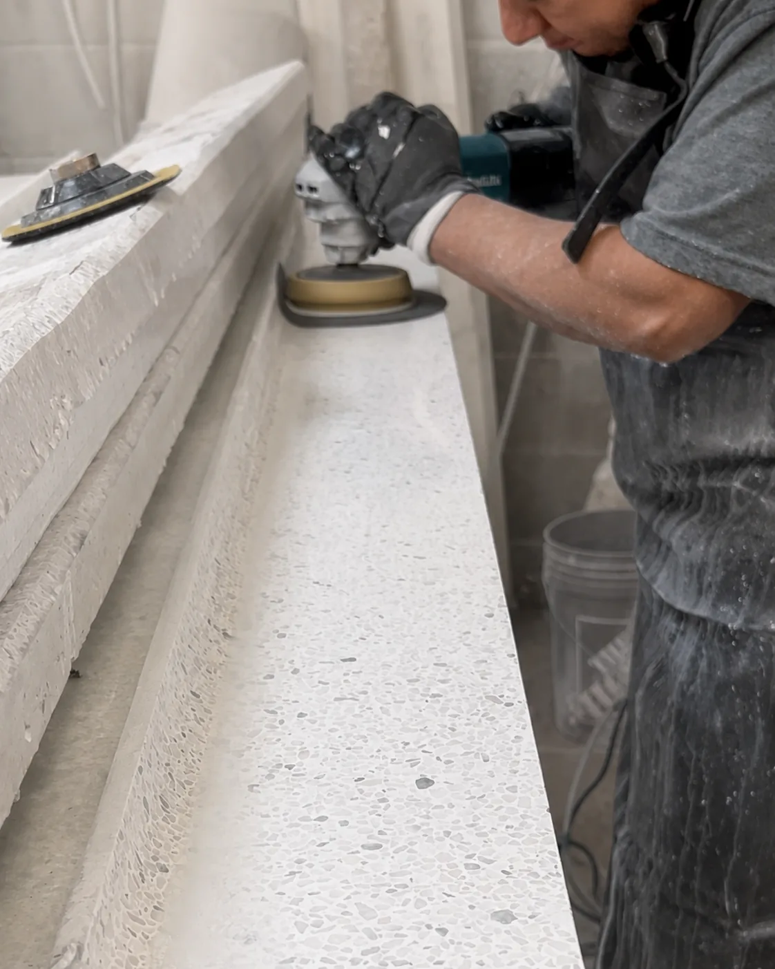 Custom terrazzo piece being shaped for installation