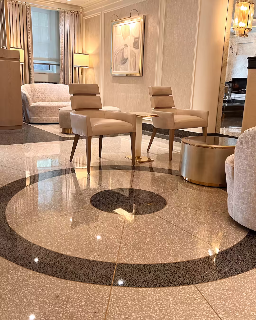Polished terrazzo flooring with circular geometric inlay at 785 Park Avenue, Manhattan.