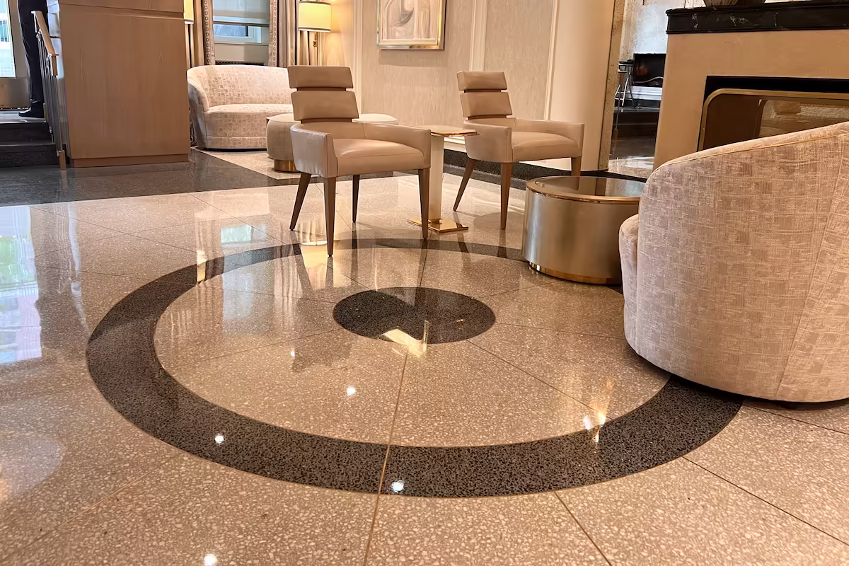 Polished terrazzo flooring with circular geometric inlay at 785 Park Avenue, Manhattan.