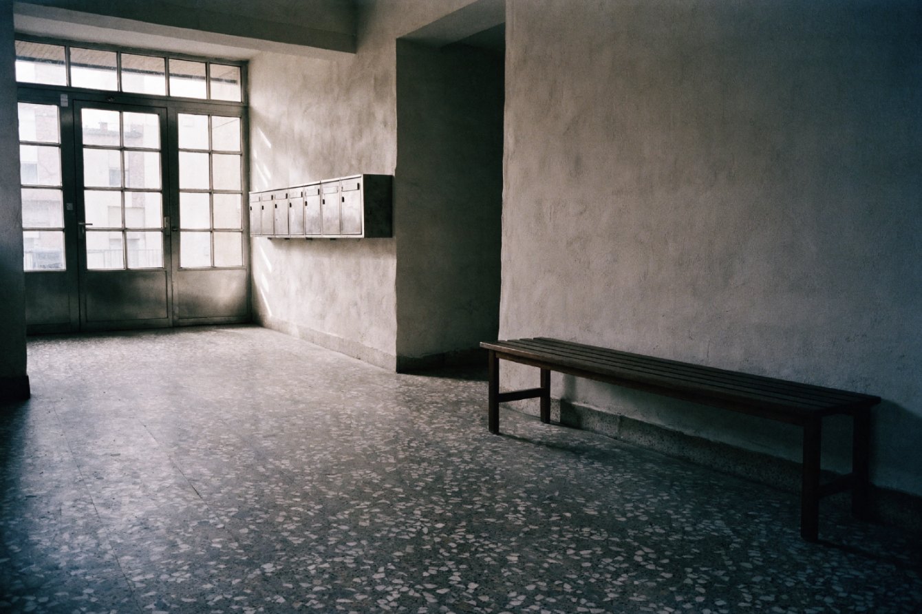 Apartment building lobby with terrazzo floor and glazed entrance doors
