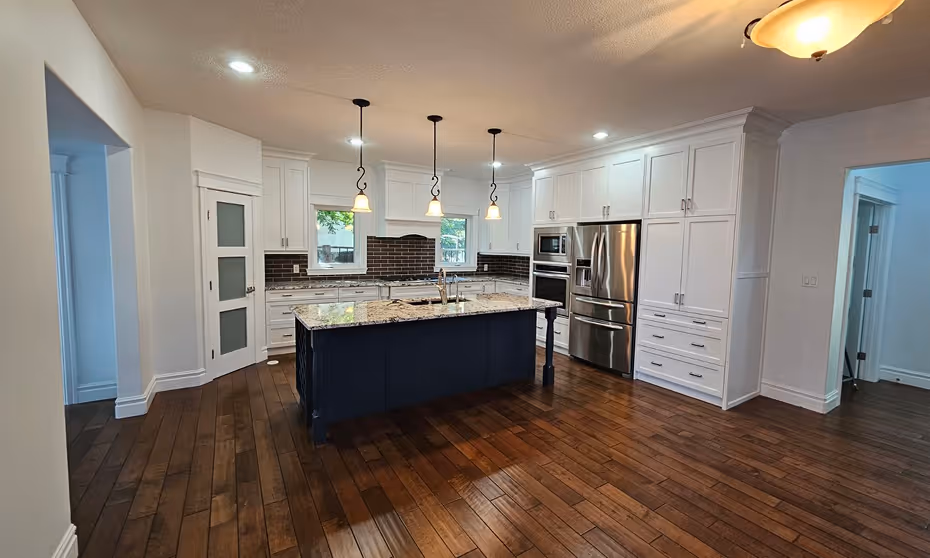 Modern kitchen with dark wood floors, white cabinets,Painted by C&C Painting in Oakmont