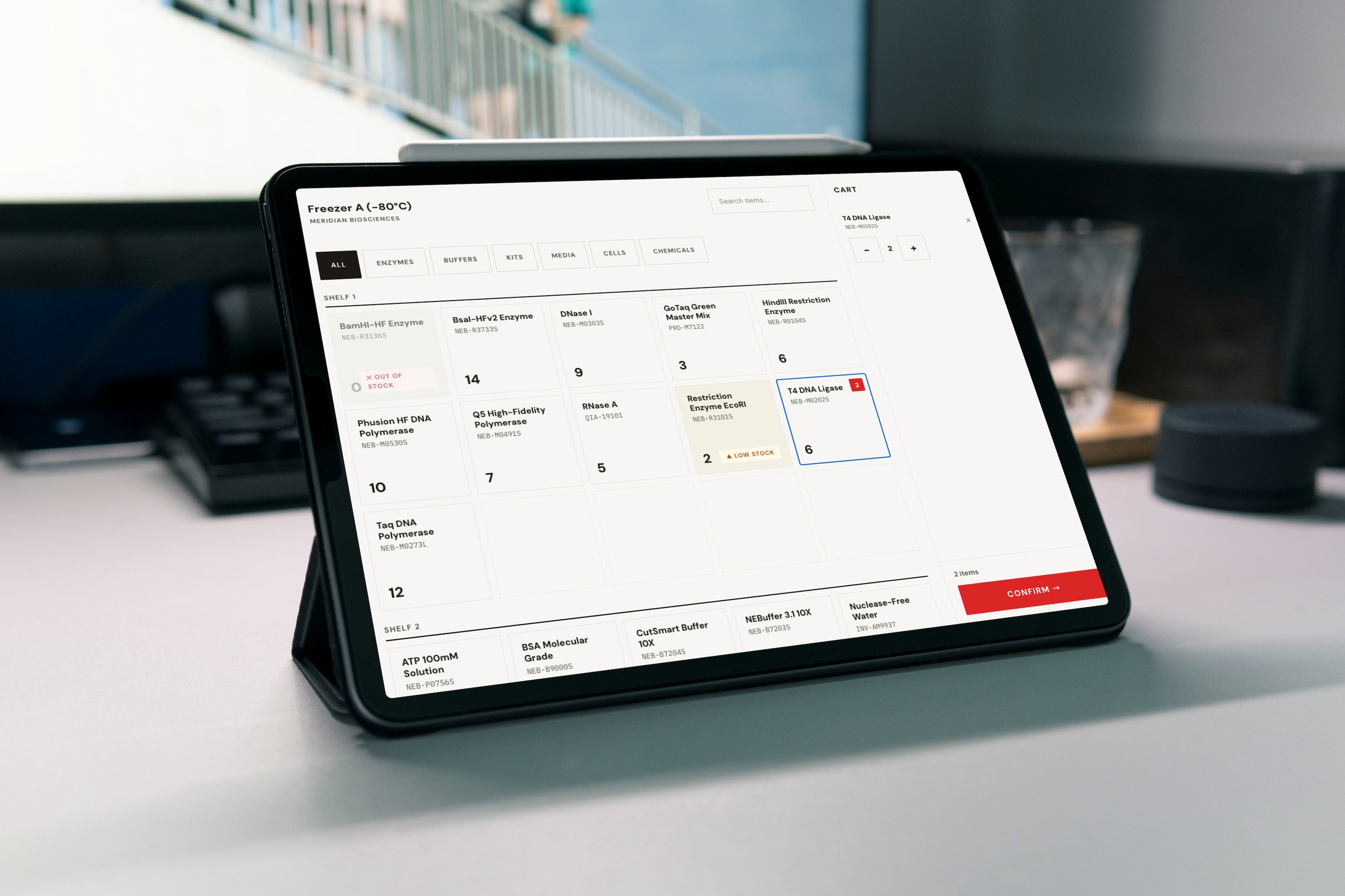 Tablet displaying inventory of enzymes and lab reagents with stock levels and cart items.