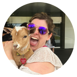Smiling woman holding a goat