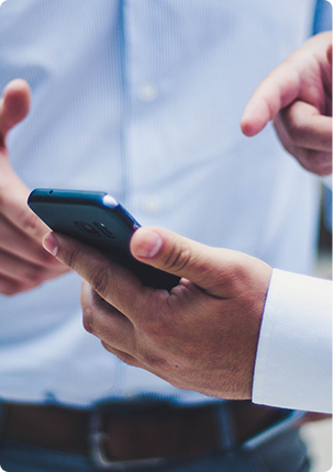 Two people using the Eventspot app builder on a smartphone.