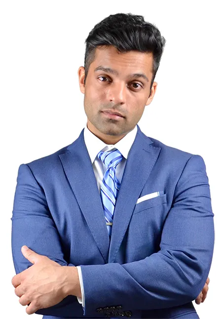 Man in blue suit and striped tie standing with arms crossed against white background.