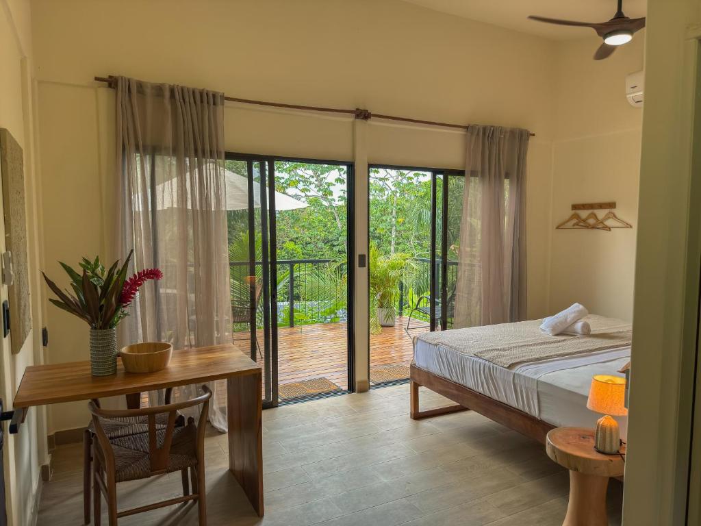 Cared-for bedroom with doors opening onto a terrace and green valley, Costa Rica