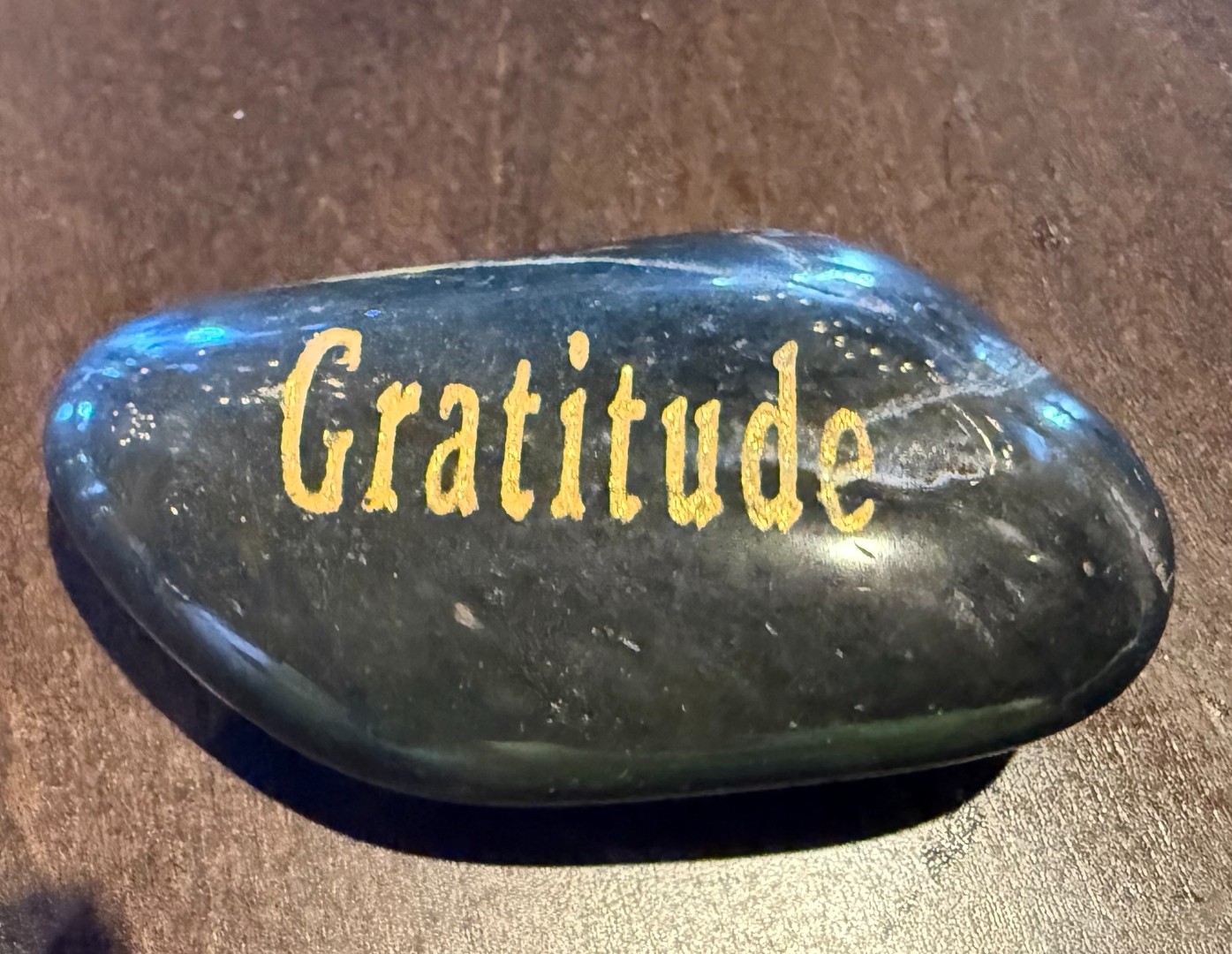 A smooth stone with the word Gratitude written on it