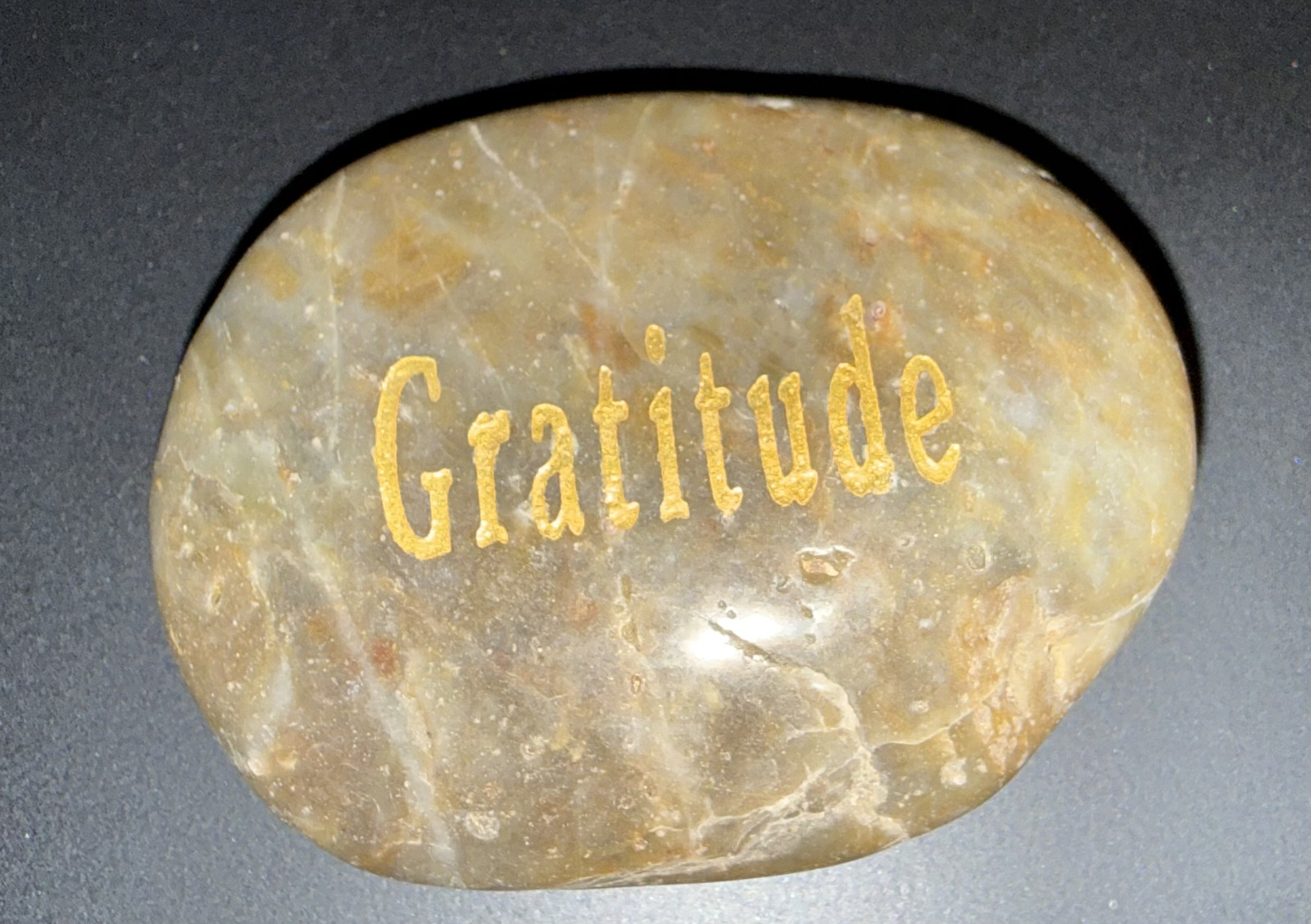 A gratitude stone photographed as part of the Gratitude Ripples practice