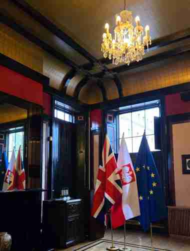 Flags and chandelier inside the Polish Embassy