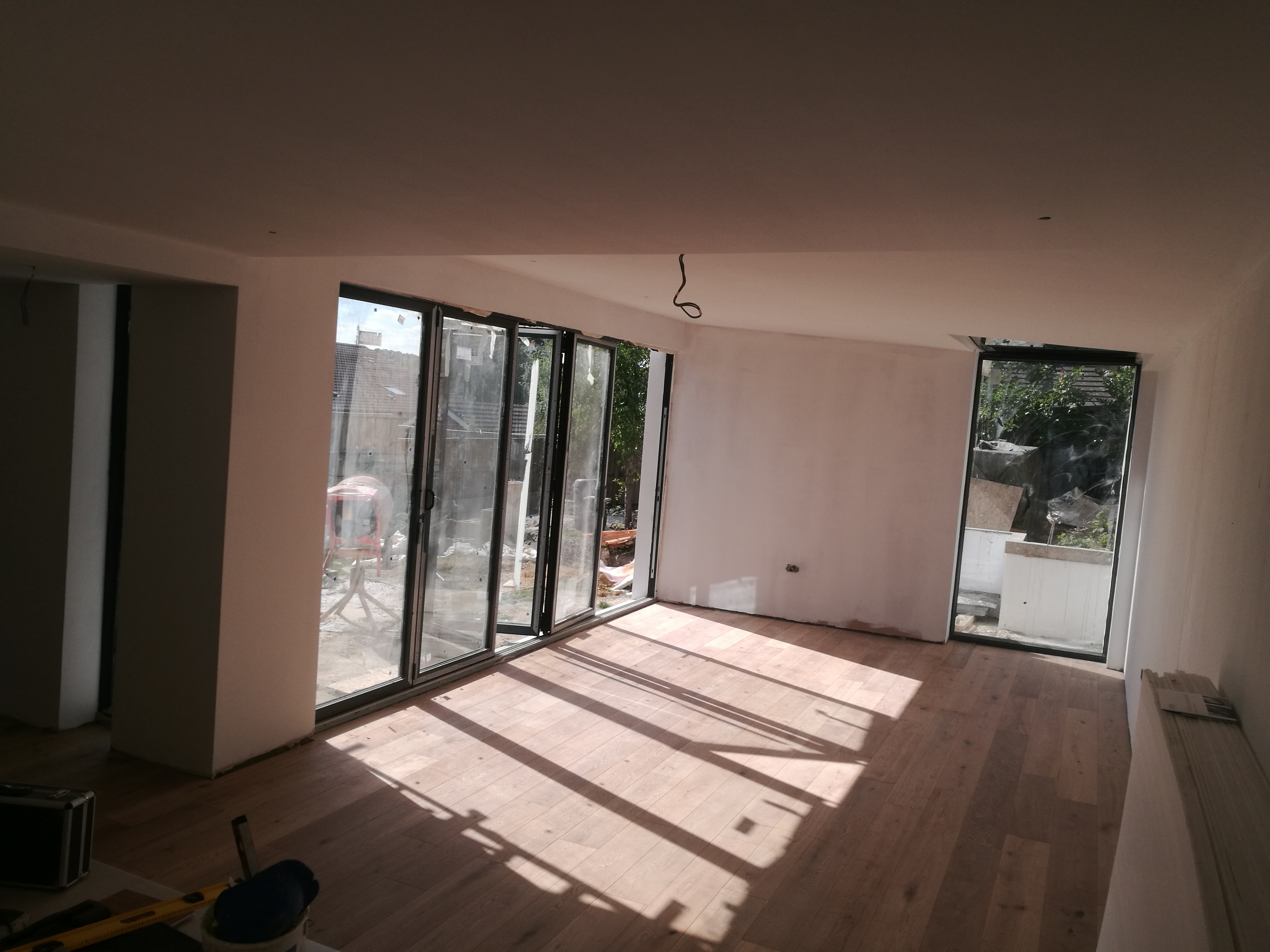 Plastered living space during construction at Hamilton Road
