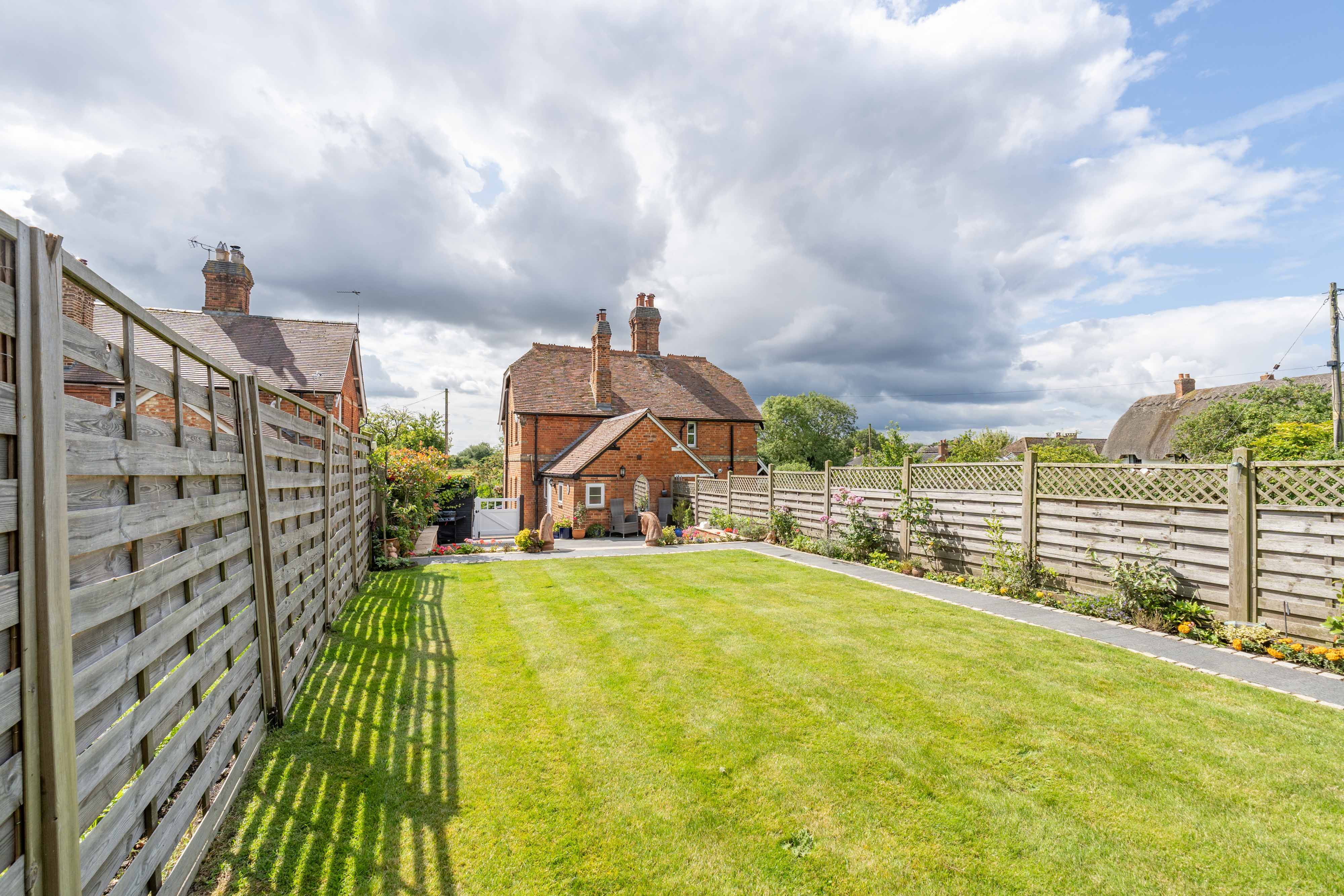 The rear garden at 12 Main Street, with the Grade II listed neighbouring cottage beyond