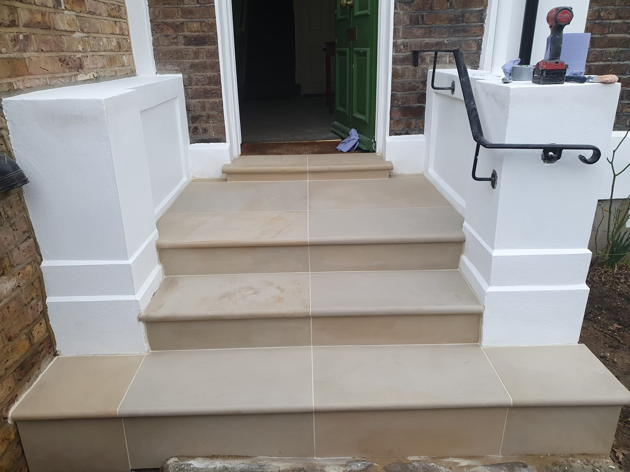 The entrance steps at 115 Ladbroke Road, re-clad in hewn natural stone with bullnose edging