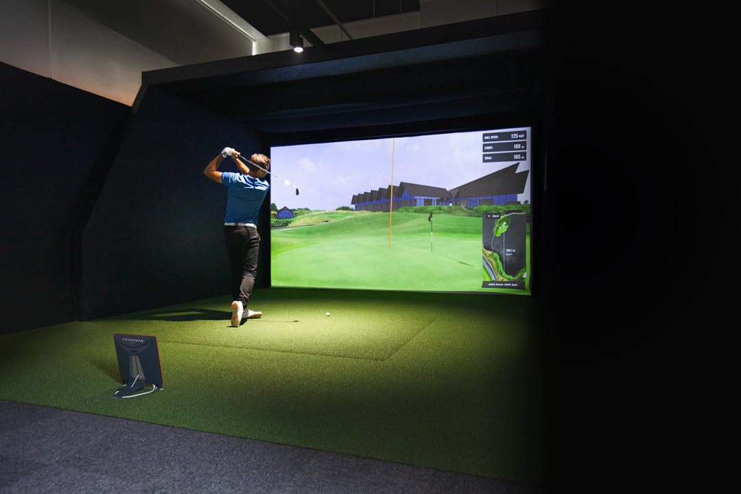 Player swinging in a Trackman simulator