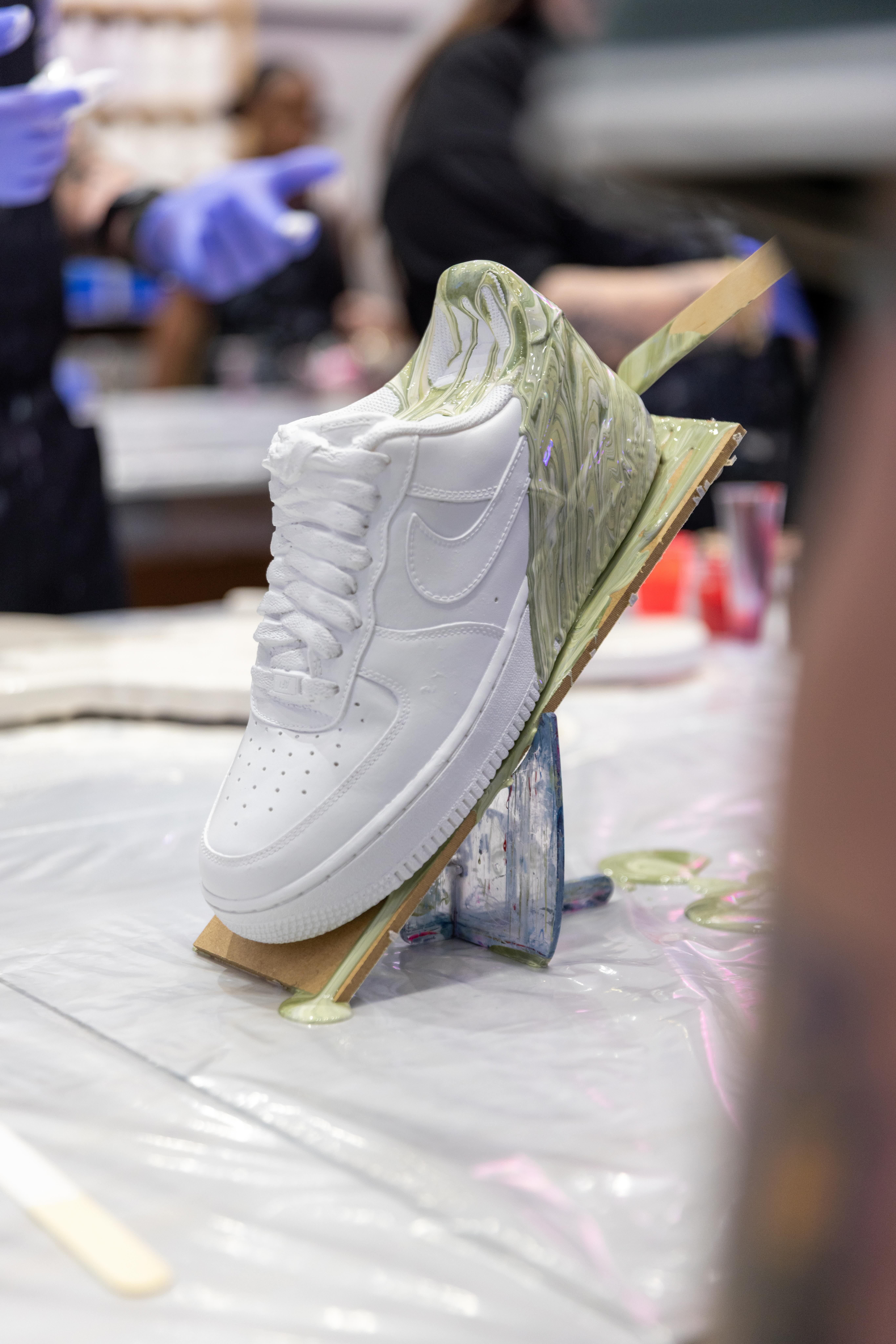 Custom fluid art sneaker being poured with paint