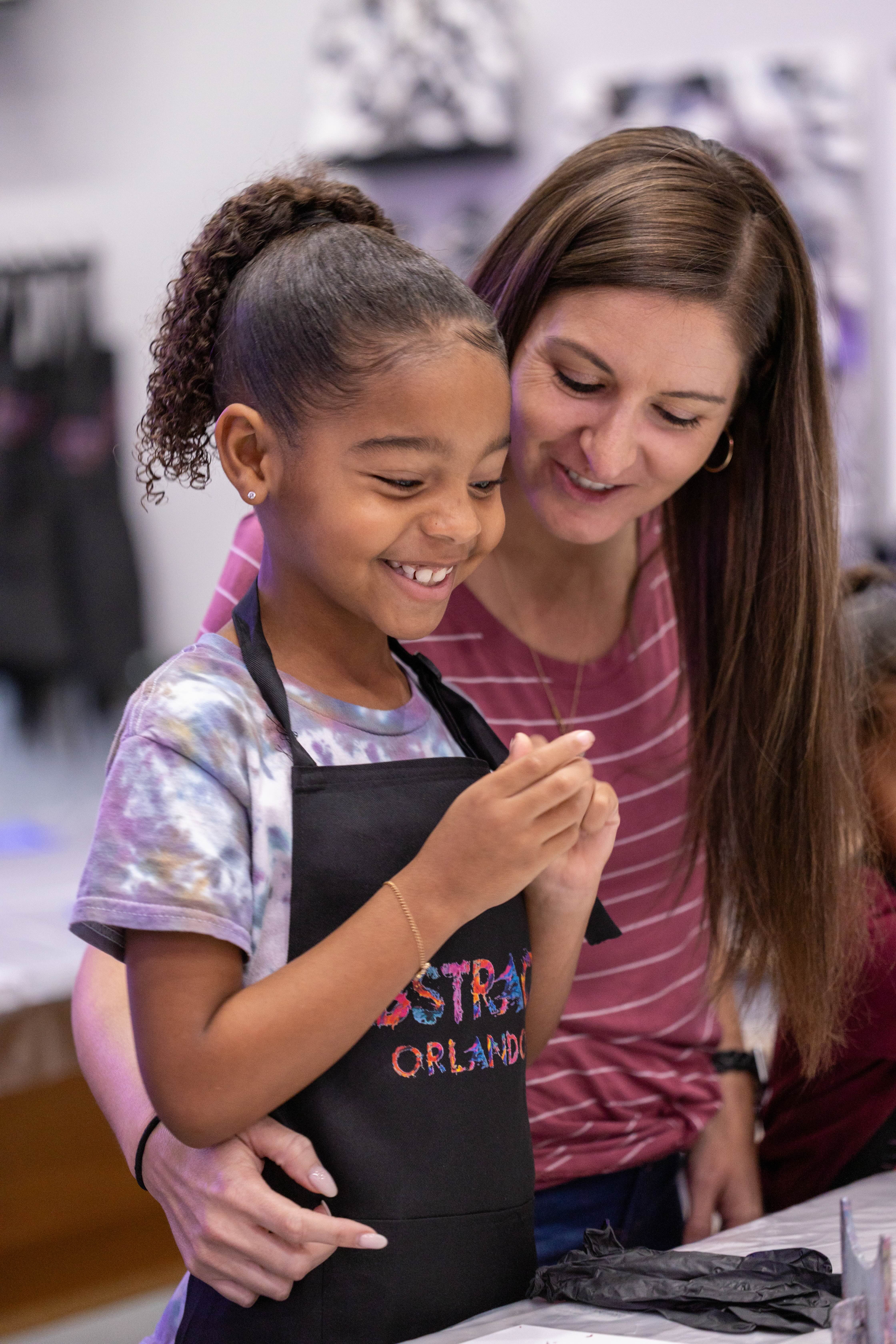 Mother and daughter smiling during a class