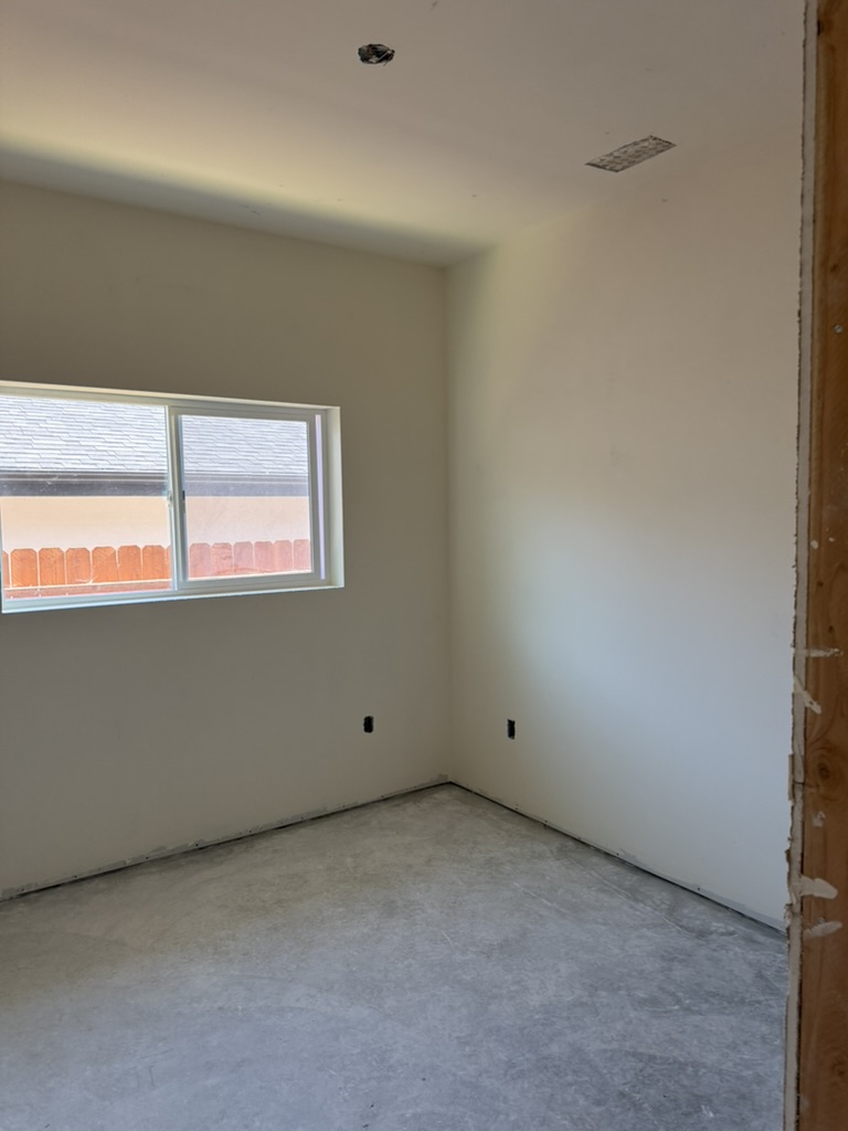 Level 5 smooth wall finish in a completed bedroom in Grover Beach