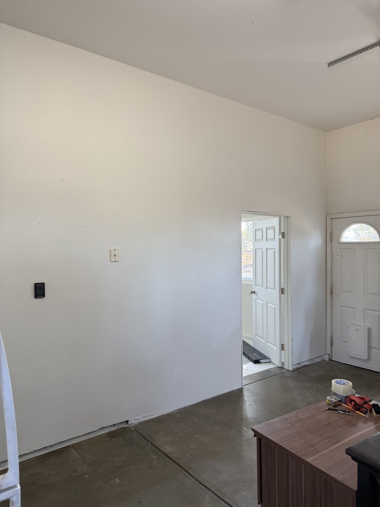 Interior drywall installation with archway opening in a San Luis Obispo residence