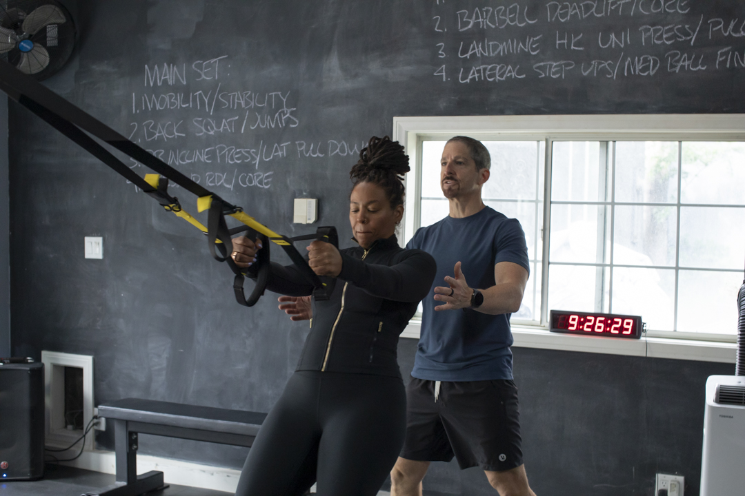 Tom Hoffman coaching a client through TRX training at Hoffman Strength Lab