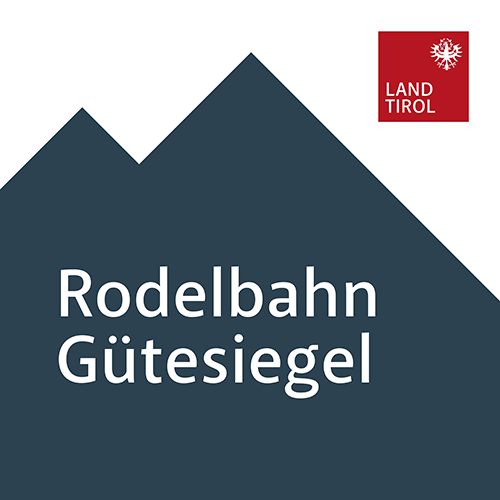Rodelbahn Gütesiegel sign with mountain silhouette and Land Tirol logo.