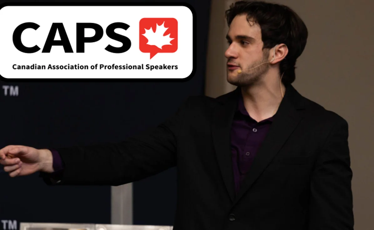 Male speaker wearing a headset microphone and black blazer, pointing to his left, with the Canadian Association of Professional Speakers logo in the background.