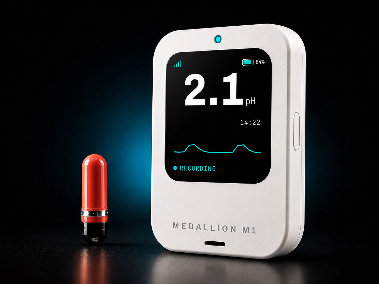 The Heidelberg pH Capsule beside the Medallion M1 reader showing a live 2.1 pH stomach-acid measurement