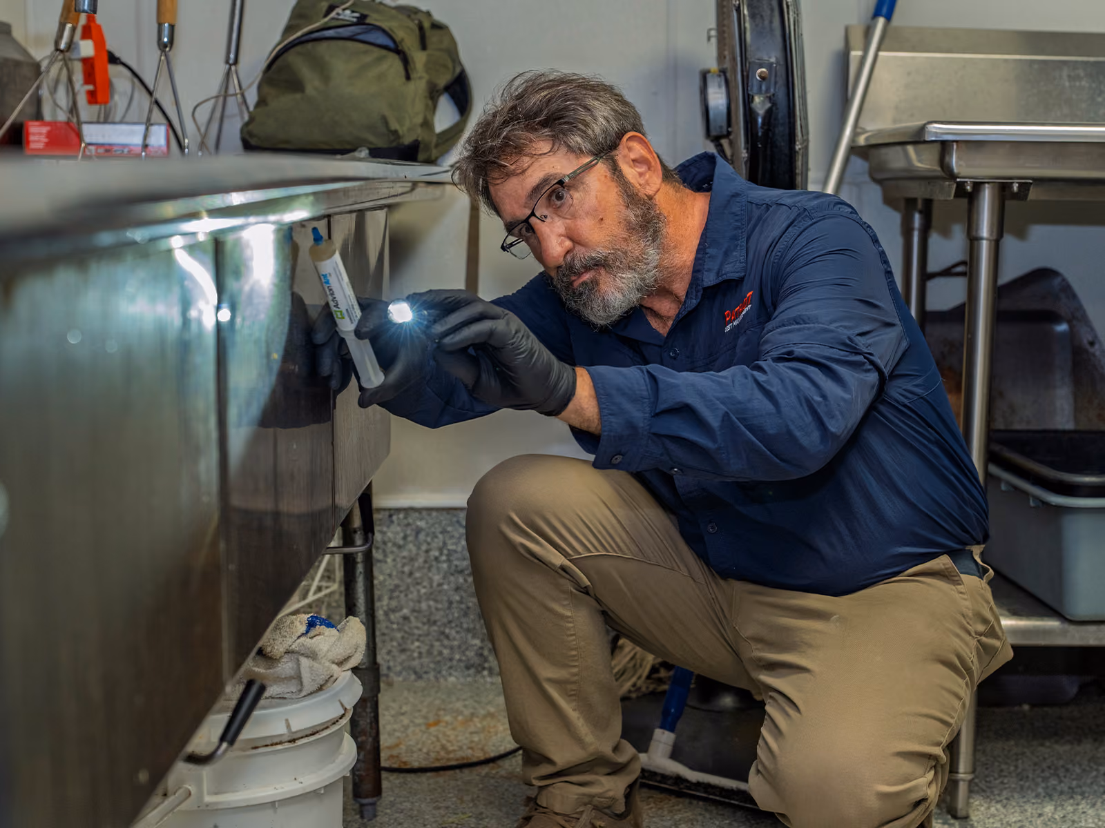 commercial technician treating a kitchen for pests