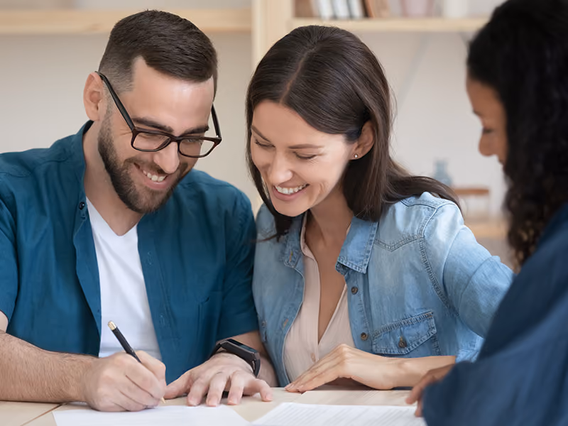 family signing paperwork for a new home in florida