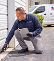pest control tech inspecting garage in pace 