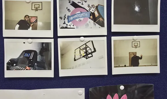 Six pinned Polaroid photos on a board, mostly showing basketball hoops and people with a ball.