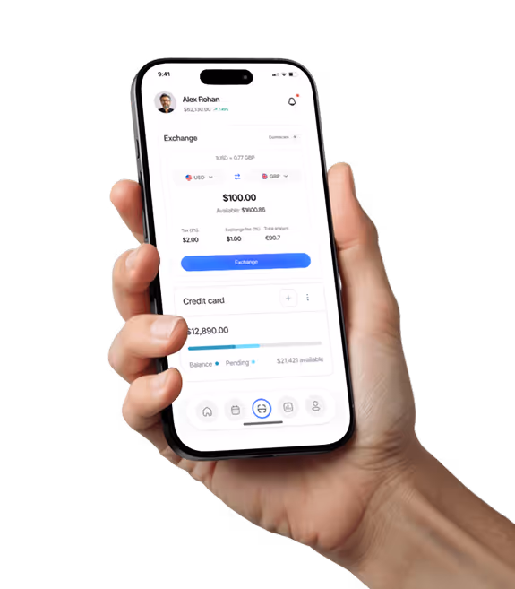 Hand holding smartphone showing currency exchange app with USD to GBP conversion and credit card balance.