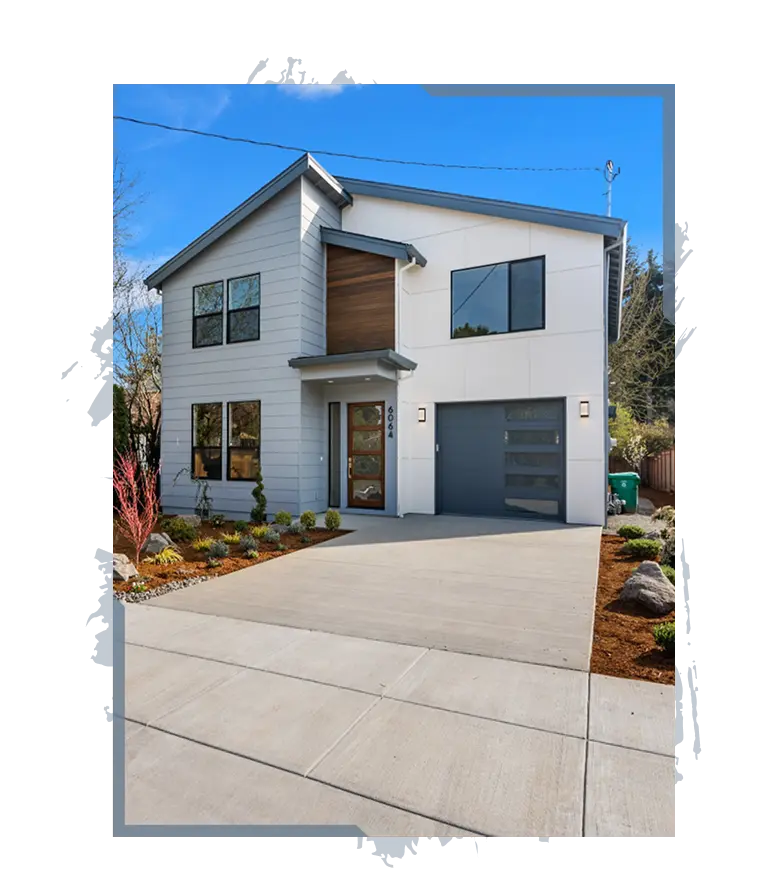 Modern two-story house with gray siding, large windows, wood accents, and a concrete driveway.