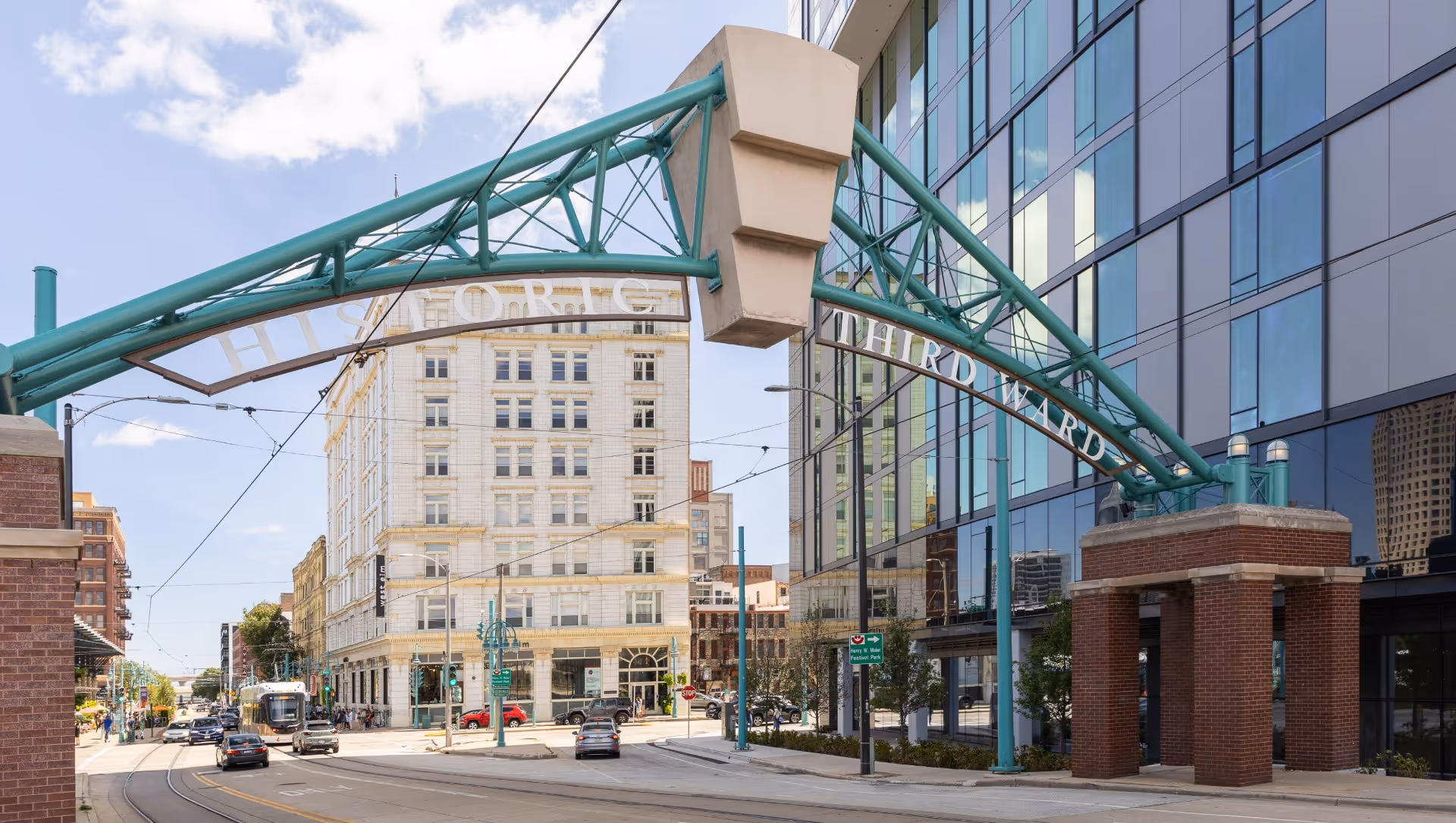 Historic Third Ward sign arching over a street with modern glass building and vintage architecture.