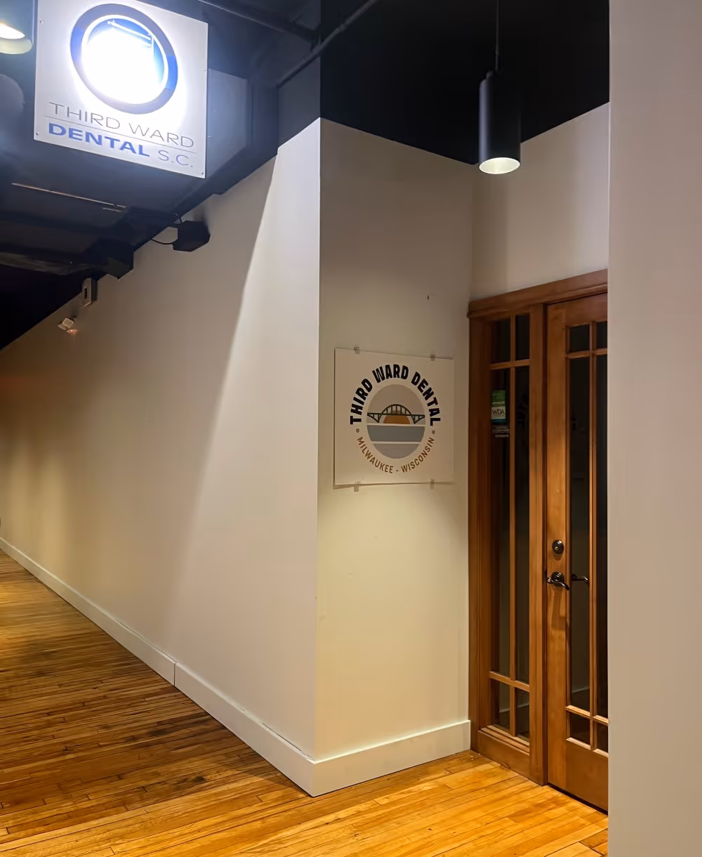Hallway with hardwood floor and Third Ward Dental office entrance with wooden double doors.
