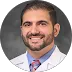 Lafi Khalil smiling in white medical coat, client testimonial portrait for Detroit Tech Solutions IT services