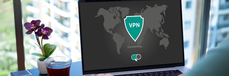 Laptop screen displaying a VPN connection interface with world map and shield icon, connecting securely