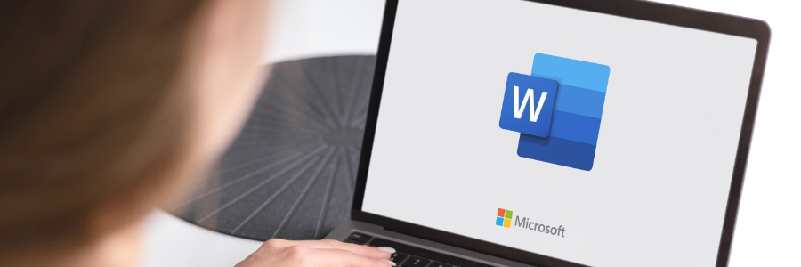 Person using laptop displaying Microsoft Word logo and Microsoft branding