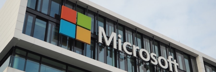 Microsoft logo and branding displayed on the exterior facade of a modern corporate office building