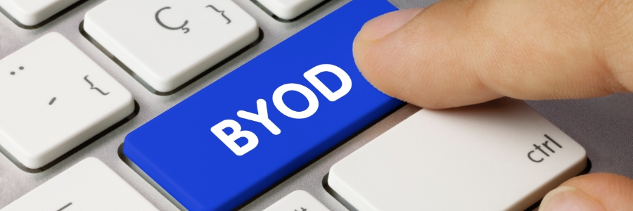 Finger pressing a blue BYOD labeled key on a white keyboard representing bring your own device IT security policy