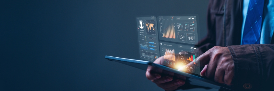 Business professional using a tablet displaying glowing holographic IT dashboard charts and analytics panels