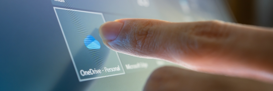 Finger tapping OneDrive Personal icon on a touchscreen interface displaying Microsoft cloud storage options