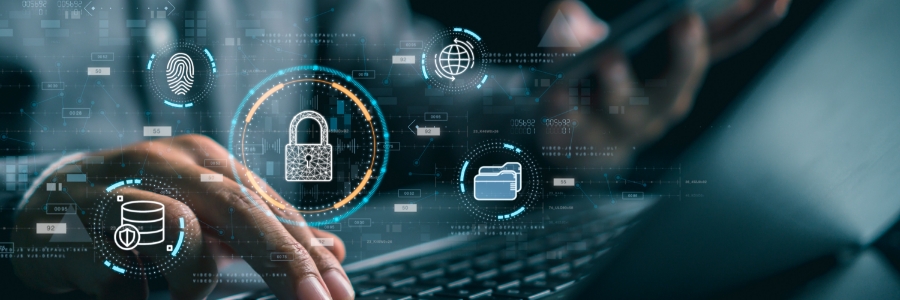 Person typing on laptop with glowing cybersecurity icons including padlock, fingerprint, globe, and database overlays