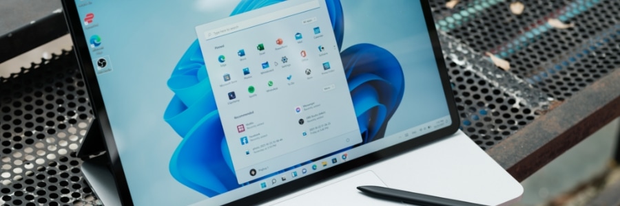 Windows 11 Start menu open on a Surface Pro tablet with stylus, showing pinned apps and recommended files